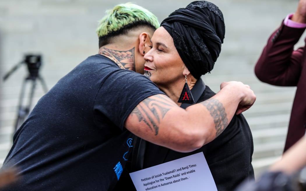 Benji Timu and Debbie Ngarewa-Packer hug after the petition is handed over.
