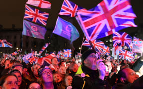 Brexit supporters wave Union flags as they watch the big screen in Parliament Square, venue for the Leave Means Leave Brexit Celebration party in central London.