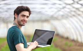 young farmer with laptop
