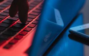 A hand enters account details on a laptop (file)