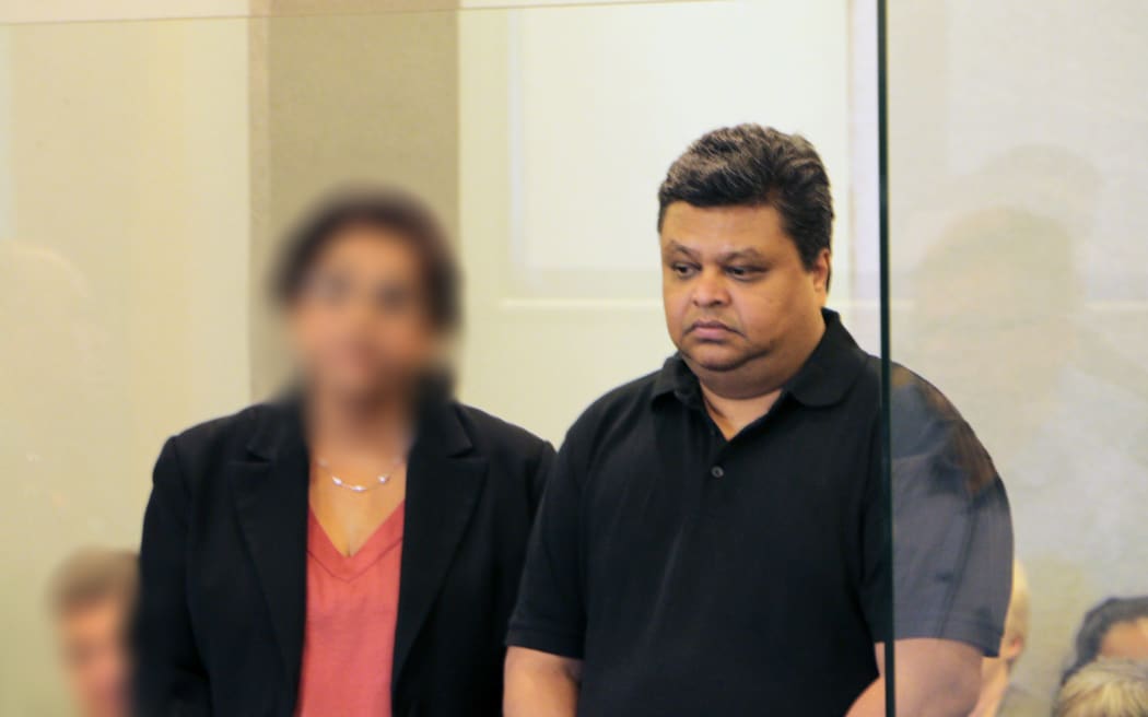 Rohit Deepak Singh standing alongside an interpreter at the High Court in Auckland.
