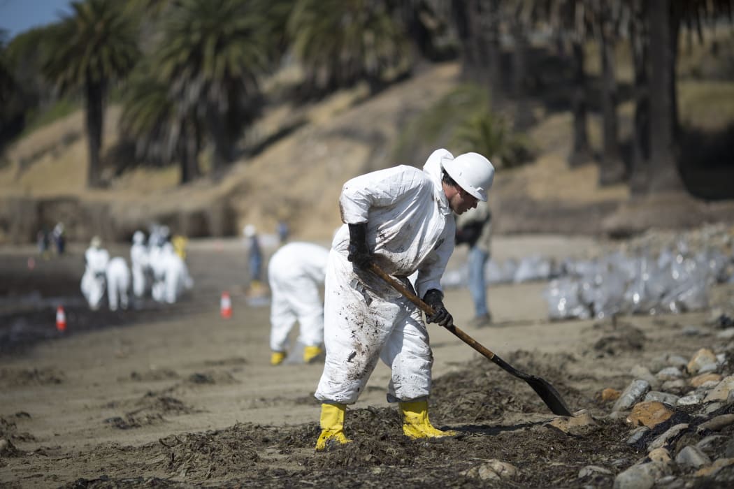 Crews clean oil from the beach at Refugio State Beach.
