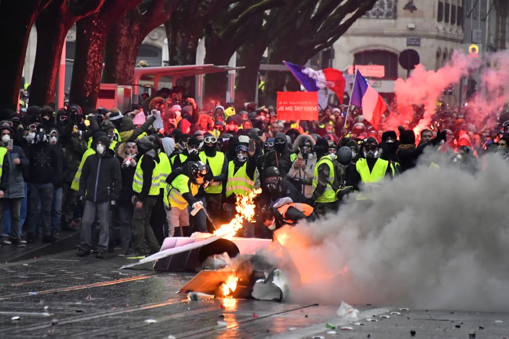 Protesters wearing yellow vests set up a barricade during a demonstration against rising costs of living they blame on high taxes in France.