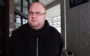 Kim Dotcom speaks briefly to media outside Auckland District court.