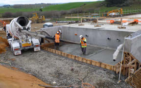 Workers lay down steel for the Huntly Bypass.