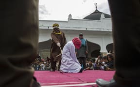 File photo of a woman in Indonesia who was previously caned in public.