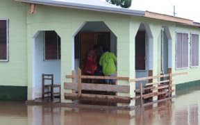Red Cross workers go door to door in Samoa to check on residents in the wake of Cyclone Gita