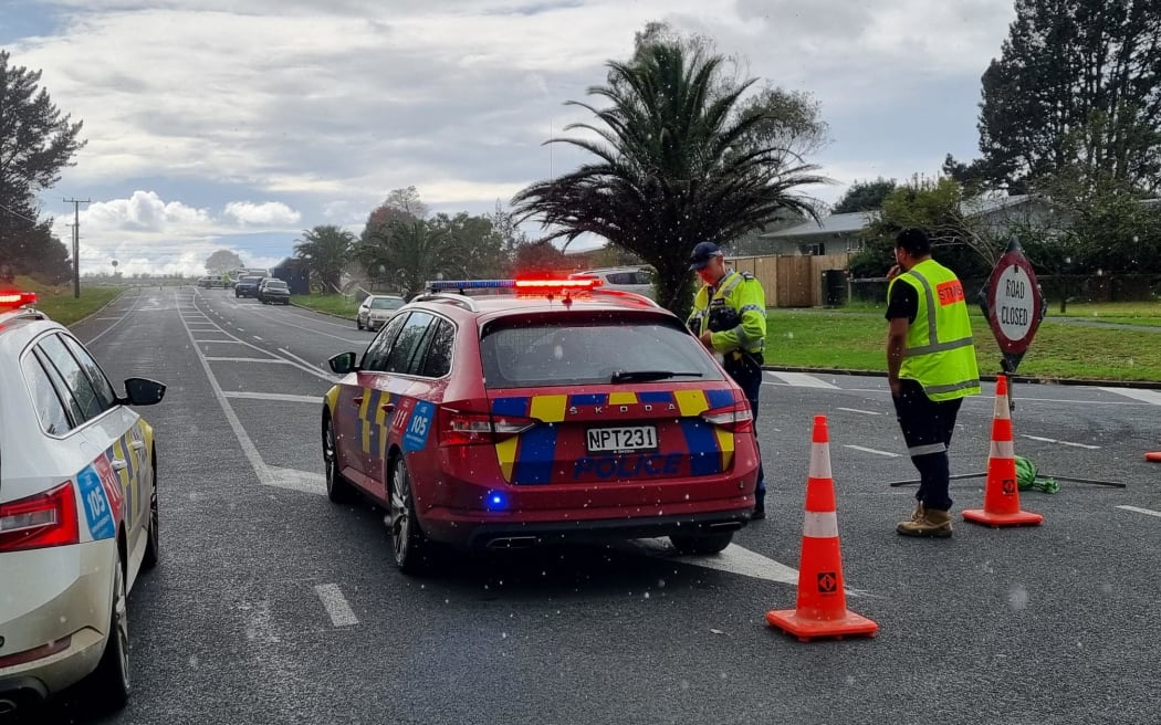 Police block the road following a double homicide in Ruakākā.