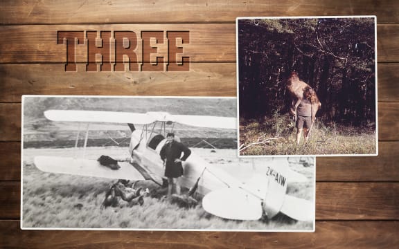 A timber wall reminiscent of a hunting hut has the word "three" stamped into it like a cattle brand. On the wall are two photos, one of a pilot stop next to a biplane and several deer carcasses, one of a hunter carrying a deer carcass over his shoulder.