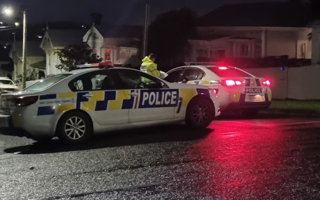 A police officer at a cordon on the corner of Murdoch Road and Dickens Street, Grey Lynn, on Tuesday 19 July 2022. Police had shot and critically injured a man who they say pointed a gun at officers on Wallingford St on Monday evening.