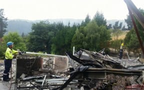 Residents sift through charred remains of homes as cordons lifted
