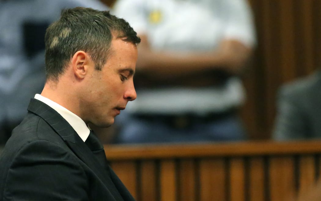 Oscar Pistorius reacts to hearing that he is to spend the next five years in jail.