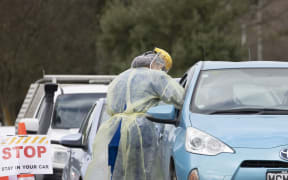 A health worker conducts a COVID-19 test in a drive through Community Based Assessment Centre in Christchurch, New Zealand, on August 14, 2020.