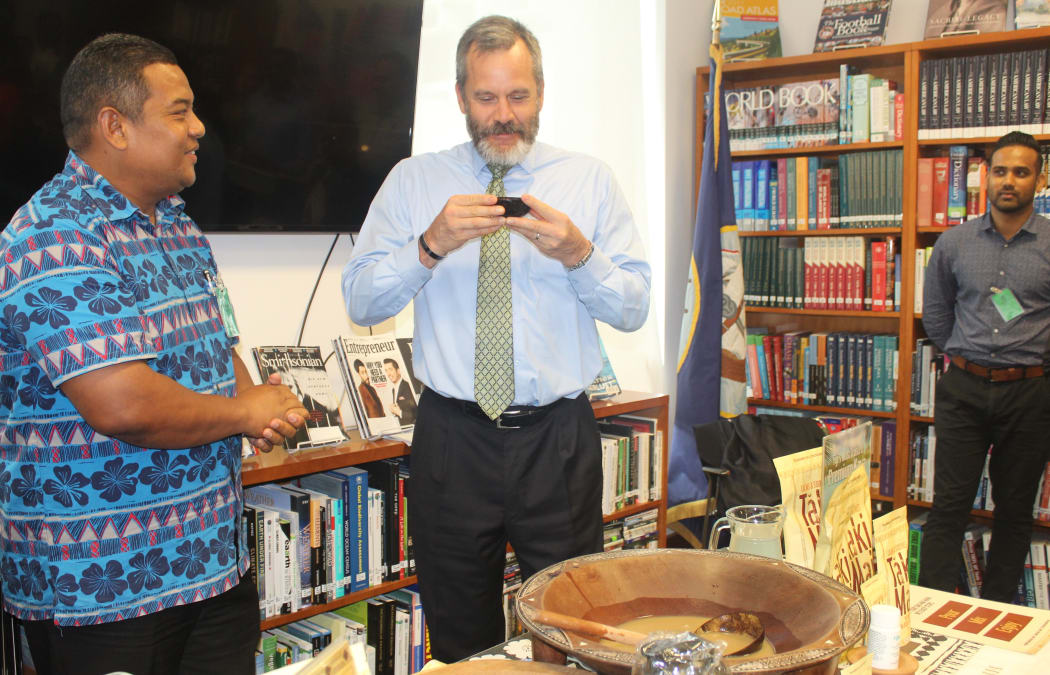 US Ambassador Joseph Cella indulges in the traditional Fijian brew as Fiji kava industry officials George Kotobalavu, left, and Shaneel Nair look on.