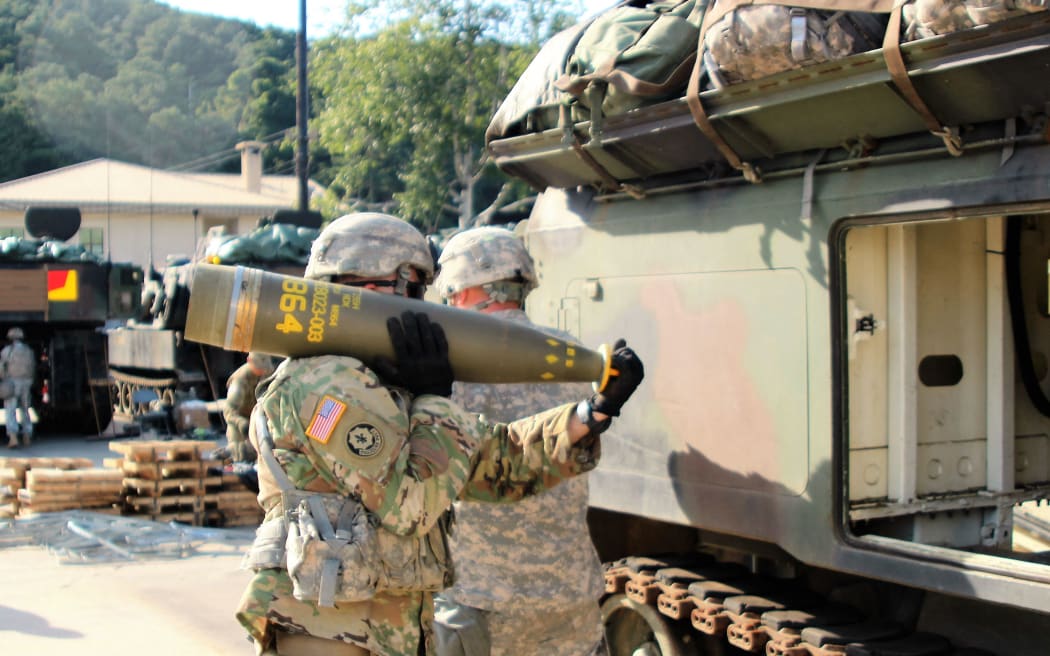 This handout picture dated September 20, 2016 courtesy DVIDS obtained on July 7, 2023 shows Soldiers from Alpha Battery, 1st Battalion, 82nd Field Artillery Regiment, 1st Armored Brigade Combat Team, 1st Cavalry Division, participate in a load exercise directed by the 210th Field Artillery Brigade, 2nd Infantry Division. The United States announced July 7, 2023 that it will provide cluster munitions to Ukraine for the first time as Kyiv's forces push ahead with a counteroffensive against Russian forces. (Photo by Handout / DVIDS / AFP) / RESTRICTED TO EDITORIAL USE - MANDATORY CREDIT 