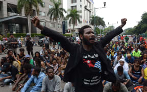 Papuan pro-independence demonstrators stage a protest in Jakarta on December 1, 2015, before police fired tear gas at a hundreds-strong crowd hurling rocks during a protest against Indonesian rule over the eastern region of Papua.
