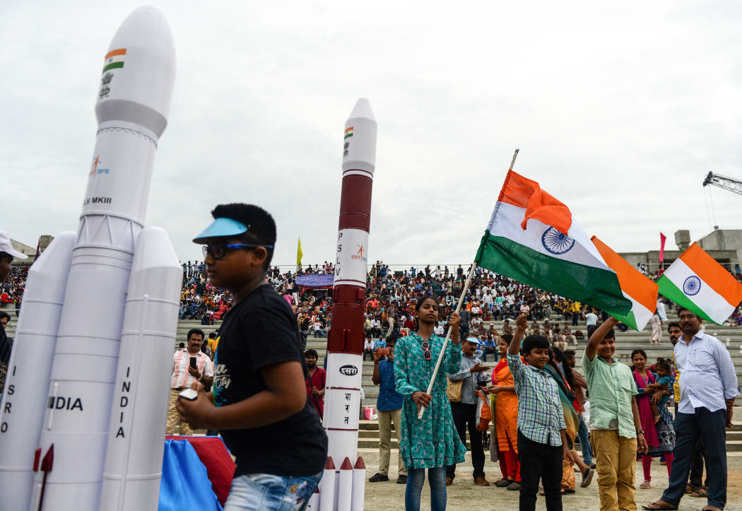 Students wave Indian national flags as the Indian Space Research Organisation's (ISRO) Chandrayaan-2 (Moon Chariot 2), with on board the Geosynchronous Satellite Launch Vehicle (GSLV-mark III-M1), has been launched in Sriharikota in the state of Andhra Pradesh on July 22, 2019.