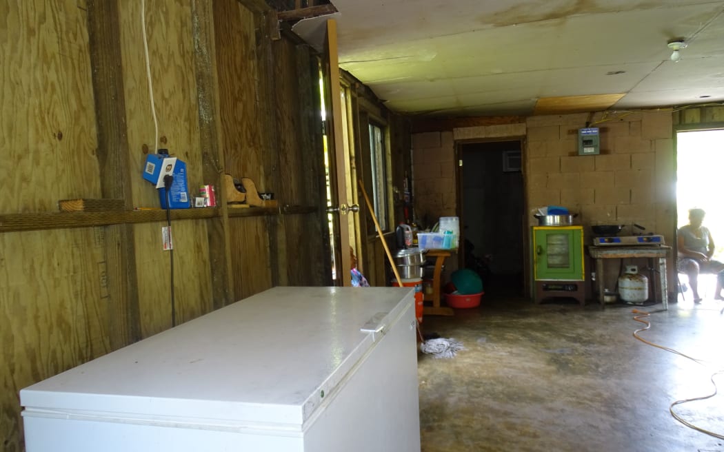 Police investigators discovered the body of three-year-old Ashley Marques in this freezer (foreground), and blood splattered on the floor leading to the room with the open door (back) where the body of her father, Robert Marques was found