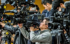 --FILE--Cameramen and photographers record a press conference during the Fourth Session of the 12th NPC (National People's Congress) at the Great Hall of the People in Beijing, China, 11 March 2016.
