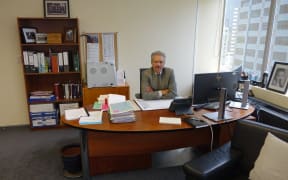 Chief Judge Wilson Isaac, the chair of the Waitangi Tribunal, sitting at his desk in Wellington.