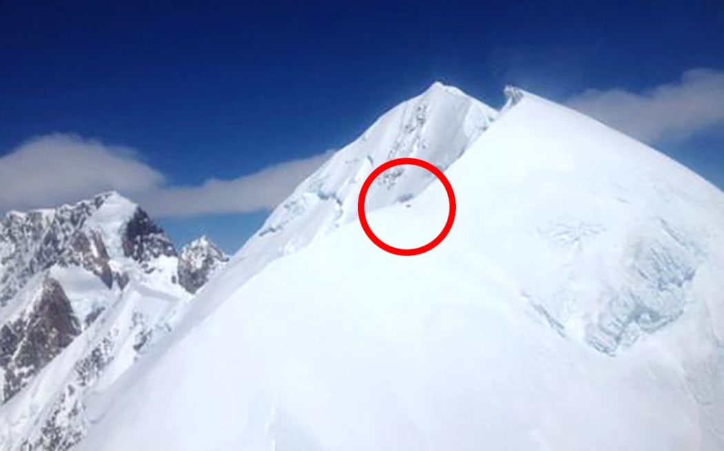 The black dot, highlighted by the circle, shows three climbers stranded on Mt Tasman.