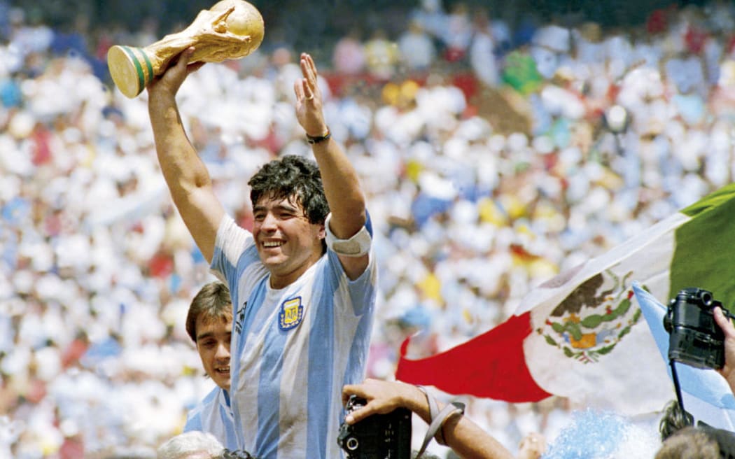 Diego Maradona of Argentina holds the World Cup trophy after defeating West Germany 3-2 during the 1986 FIFA World Cup Final match at the Azteca Stadium on June 29, 1986 in Mexico City, Mexico.