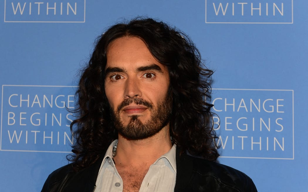 (FILES) Actor Russell Brand poses on arrival with director David Lynch (not pictured) to launch “Meditation in Education”, a Global Outreach campaign to teach 1,000,000 at-risk youth "Meditation in Education" on April 2, 2013 in Los Angeles, California. British comedian and actor Russell Brand has been accused of rape, sexual assaults and emotional abuse during a seven-year period, according to the results of a media investigation published on September 16, 2023. (Photo by Frederic J. BROWN / AFP)