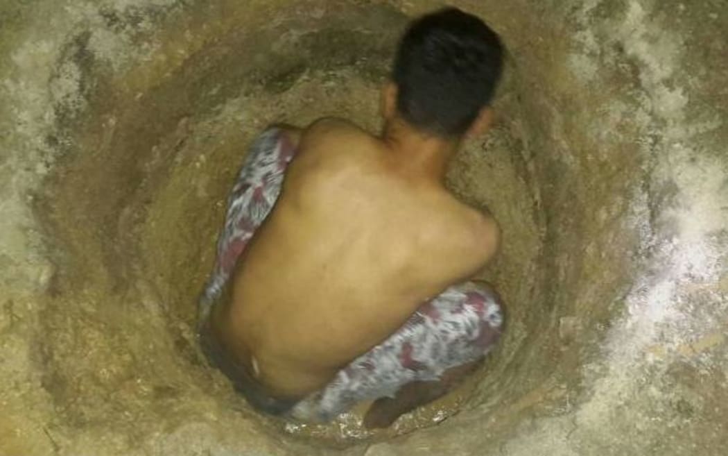 A Manus Island refugee digging a well.