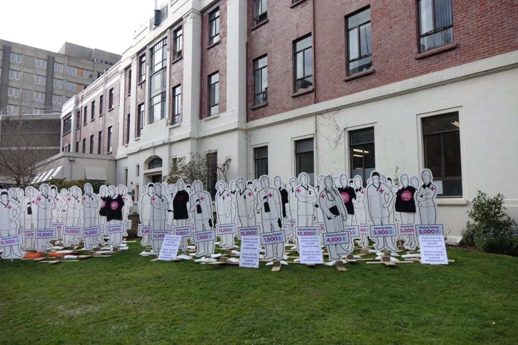 100 cardboard cutouts highlight what protesters say are the missing 30,000 staff not being funded in the health sector.