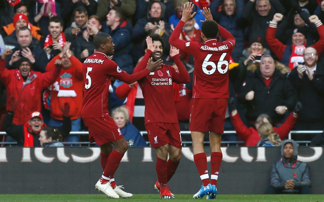 Mohamed Salah of Liverpool celebrates with his team mates after he scores.