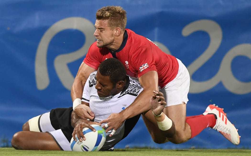 Fiji's Jasa Veremalua scores a try in the men’s rugby sevens gold medal match between Fiji and Britain during the Rio 2016 Olympic Games at Deodoro Stadium in Rio de Janeiro on August 11, 2016.
