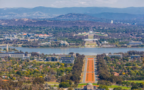 View of Canberra  from Mount Ainslie lookout - ANZAC Parade, Parliament House and modern architecture with mountains in background.