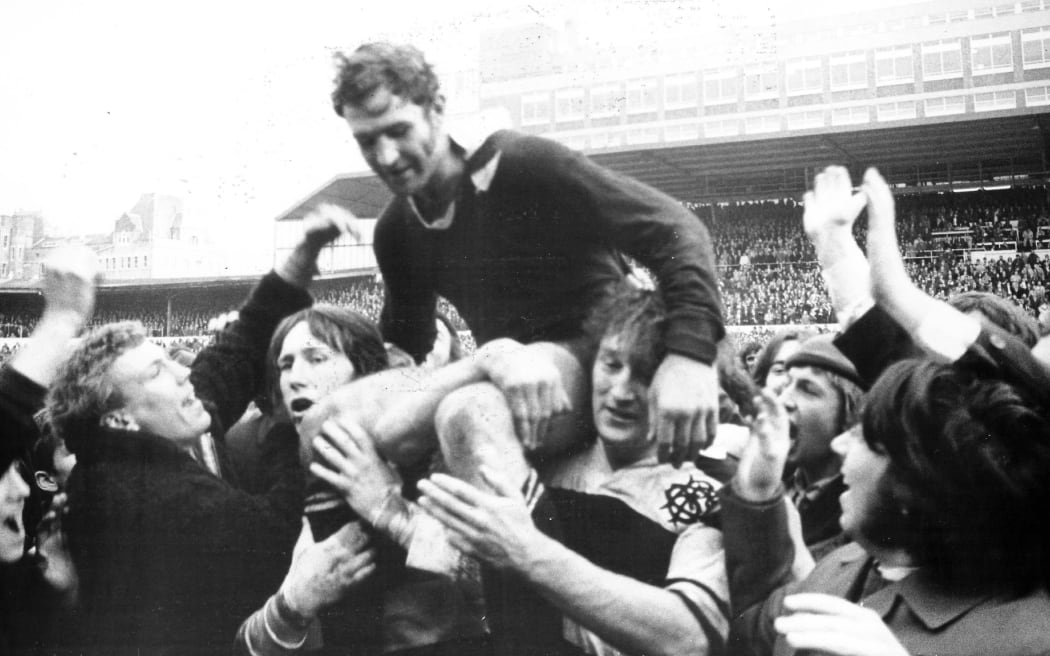 Ian Kirkpatrick hoisted onto shoulders in a game against the Barbarians, 21 January 1973. New Zealand All Blacks rugby union archive.