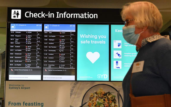 A woman proceeds to the check-in counter for New Zealand flights at Sydney International Airport on April 19, 2021, as Australia and New Zealand opened a trans-Tasman quarantine-free travel bubble.