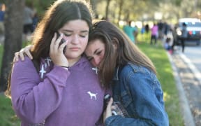 Students react following the shooting at Marjory Stoneman Douglas High School in Parkland, Florida.