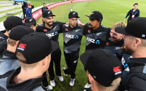The Black Caps huddle together before taking to the field.