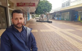 Hutt City Councillor Campbell Barry with an empty shopping centre in the background.