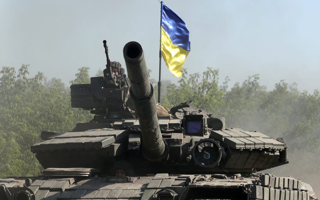 Ukrainian troops ride a tank on a road of the eastern Ukrainian region of Donbas on 21 June, 2022, as Ukraine says Russian shelling has caused 'catastrophic destruction' in the eastern industrial city of Lysychansk, which lies just across a river from Severodonetsk where Russian and Ukrainian troops have been locked in battle for weeks.