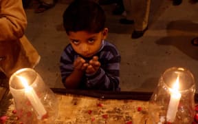 A candle-lit vigil was held in Karachi in memory of the victims of the Taliban assault on a Peshawar school.