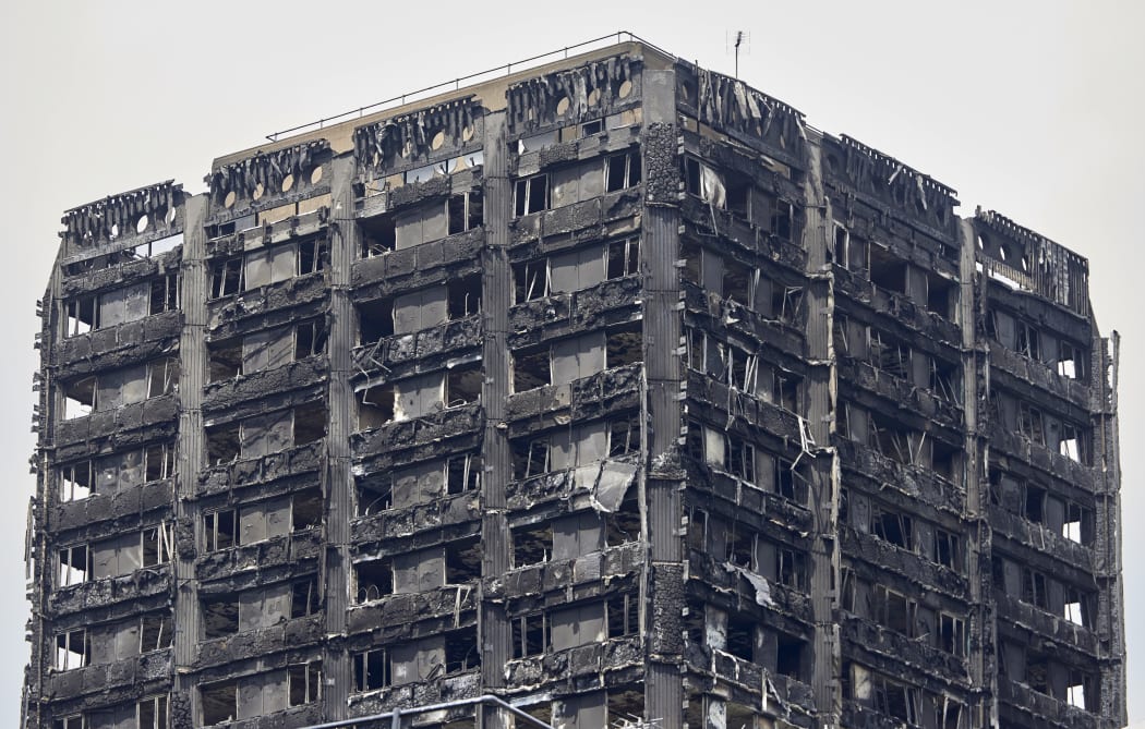 The charred remains of clading are pictured on the outer walls of the burnt out shell of the Grenfell Tower block in north Kensington, west London on June 22, 2017.