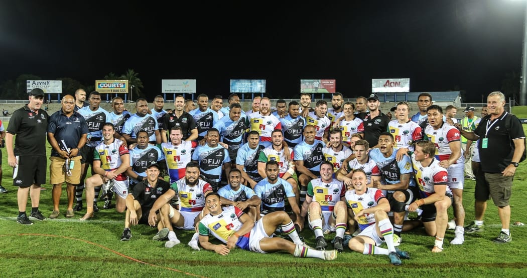 The Fijian Drua and Sydney Rays team pose together post-match.