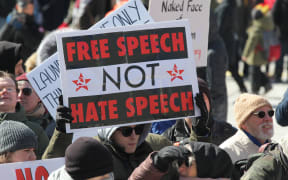 A pro-Muslim protestor carrying a sign saying 'Free Speech NOT Hate Speech' as opposing groups of protesters clashed over the M-103 motion to fight Islamophobia during pro-Muslim and anti-Muslim demonstrations in downtown Toronto; Ontario; Canada; on March 04; 2017.