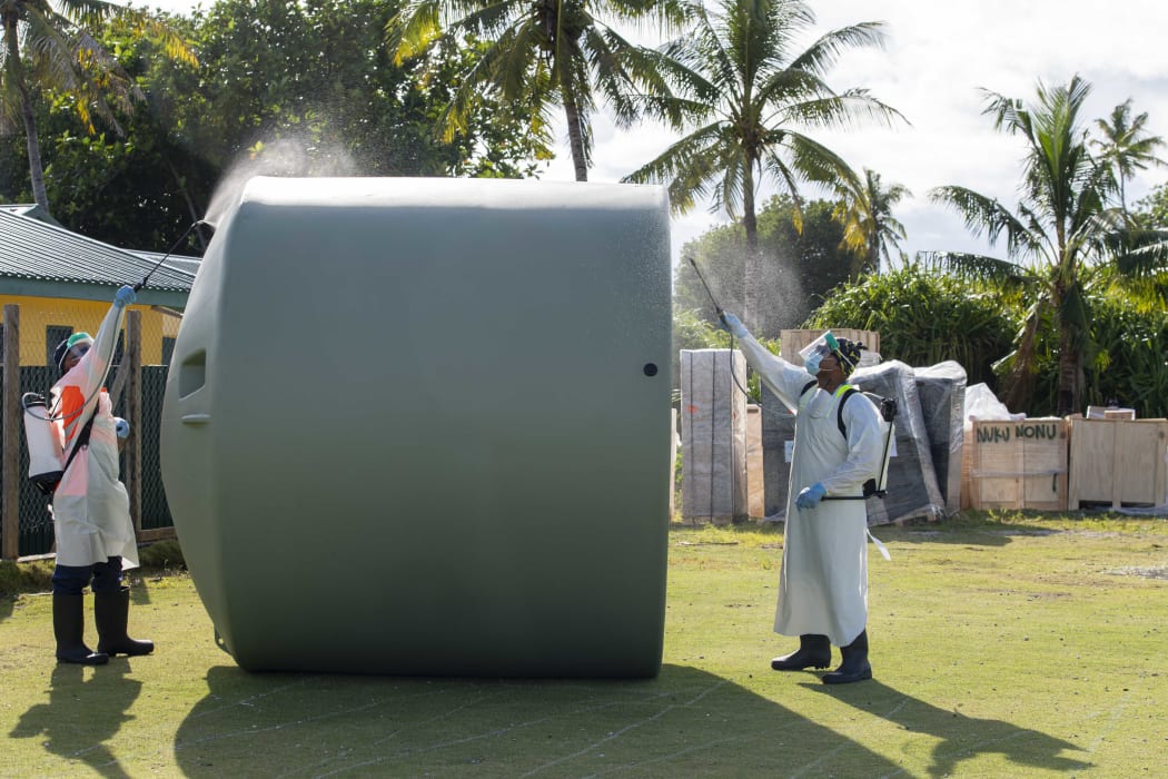 A water tank is disinfected on delivery in Tokelau by the NZDF.