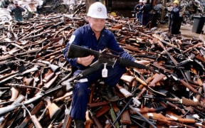 Norm Legg, a project supervisor with a local security firm, holds up an armalite rifle which is similar to the one used in the Port Arthur massacre and has been handed in for scrap 08 September in Melbourne.