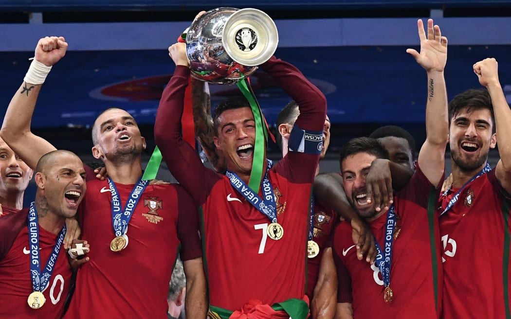 Portugal captain Cristiano Ronaldo holds up the winners' trophy as he celebrates with (from left) Ricardo Quaresma, Pepe, Joao Moutinho and Adrien Silva.