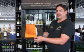 Barman Tane Rogers, of Te Arawa. At Karaka Cafe, staff kōrero in Te Reo and it is included on the menu and on store signage.