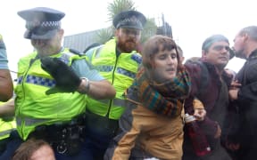 Police try to move on protesters outside the NZ Petroleum Conference in New Plymouth.