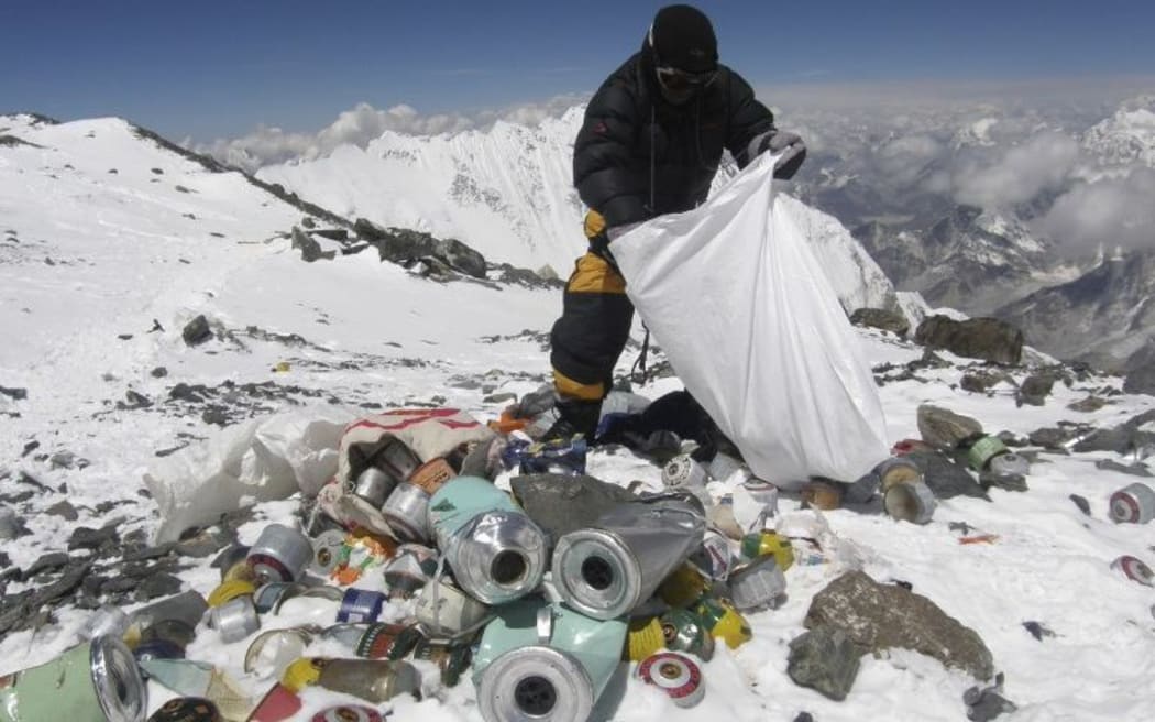 This picture taken on May 23, 2010 shows a Nepalese sherpa collecting garbage, left by climbers, at an altitude of 8,000 metres during the Everest clean-up expedition at Mount Everest. A group of 20 Nepalese climbers, including some top summiteers collected 1,800 kilograms of garbage.
