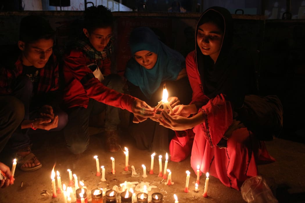 The Pakistani Civil Society light candles at a vigil in Karachi for the victims of last year's school attack by Taliban militants in Peshawar, on December 16, 2015.