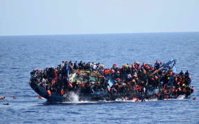 An image released by the Italian Navy shows the shipwreck of an overcrowded boat of migrants off the Libyan coast.